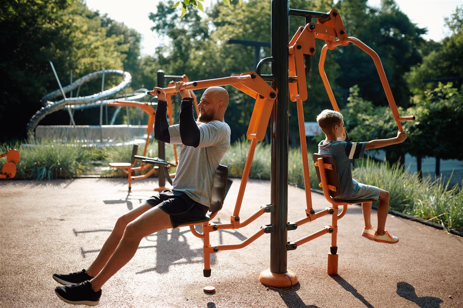 father-and-child-on-exercise-machine-playground-2026-03-16-06-31-20-utc